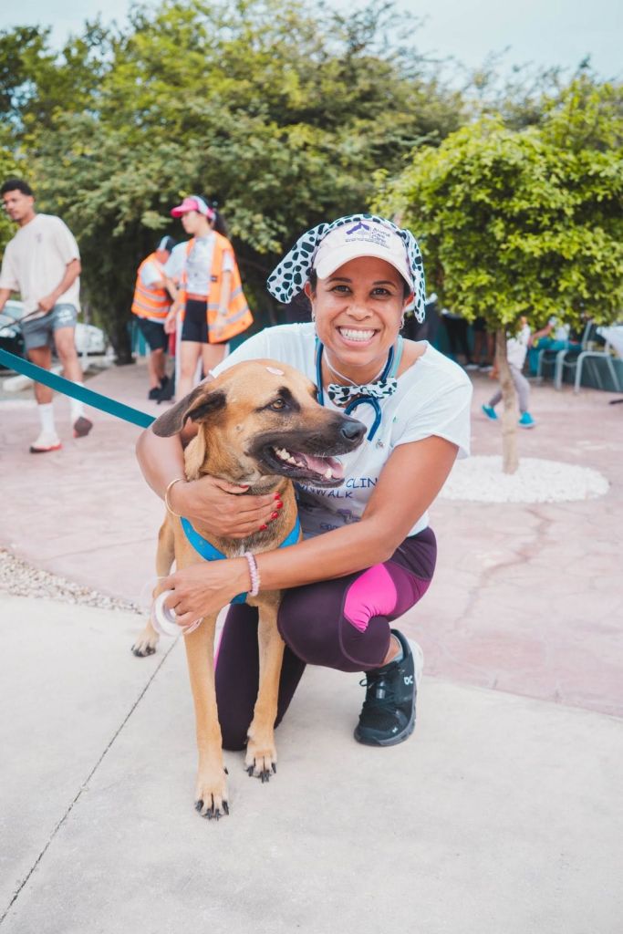Veterinarian hugging a dog at the Animal Care Clinic Aruba Fun Walk